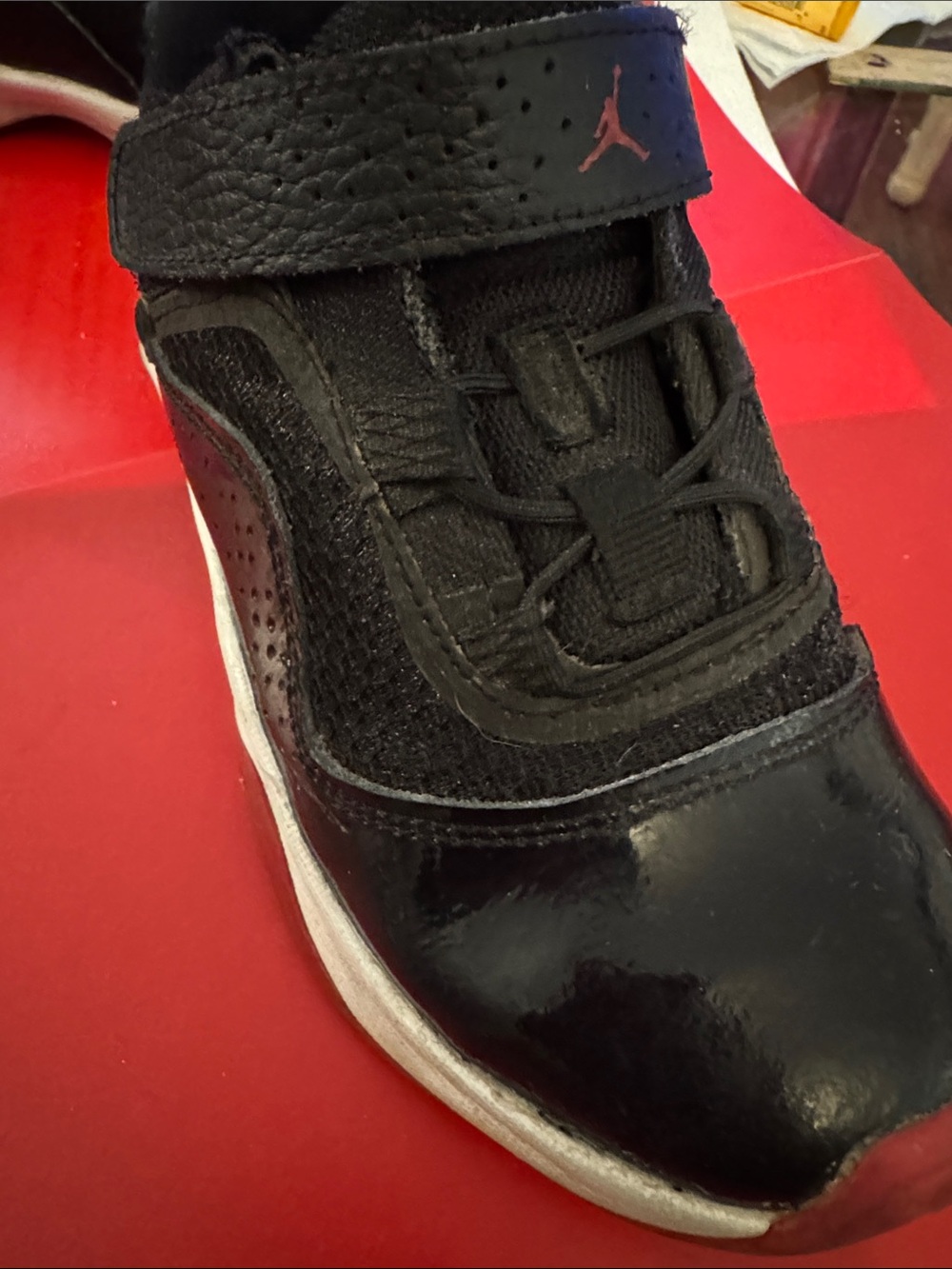 Nike Jordan 11 patent Black Sneaker with Red Jumpman Accent